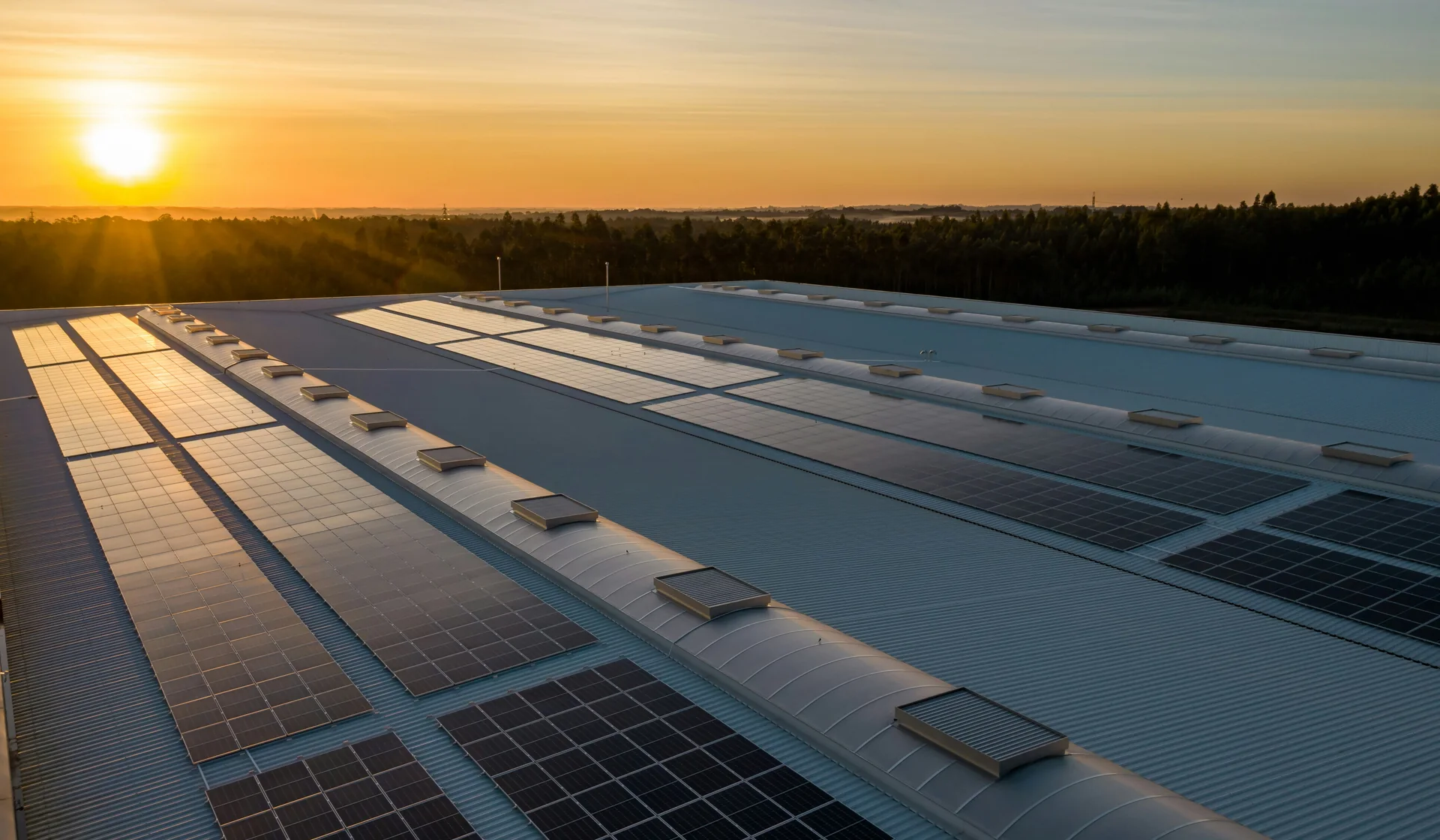 Commercial rooftop solar installation at sunset
